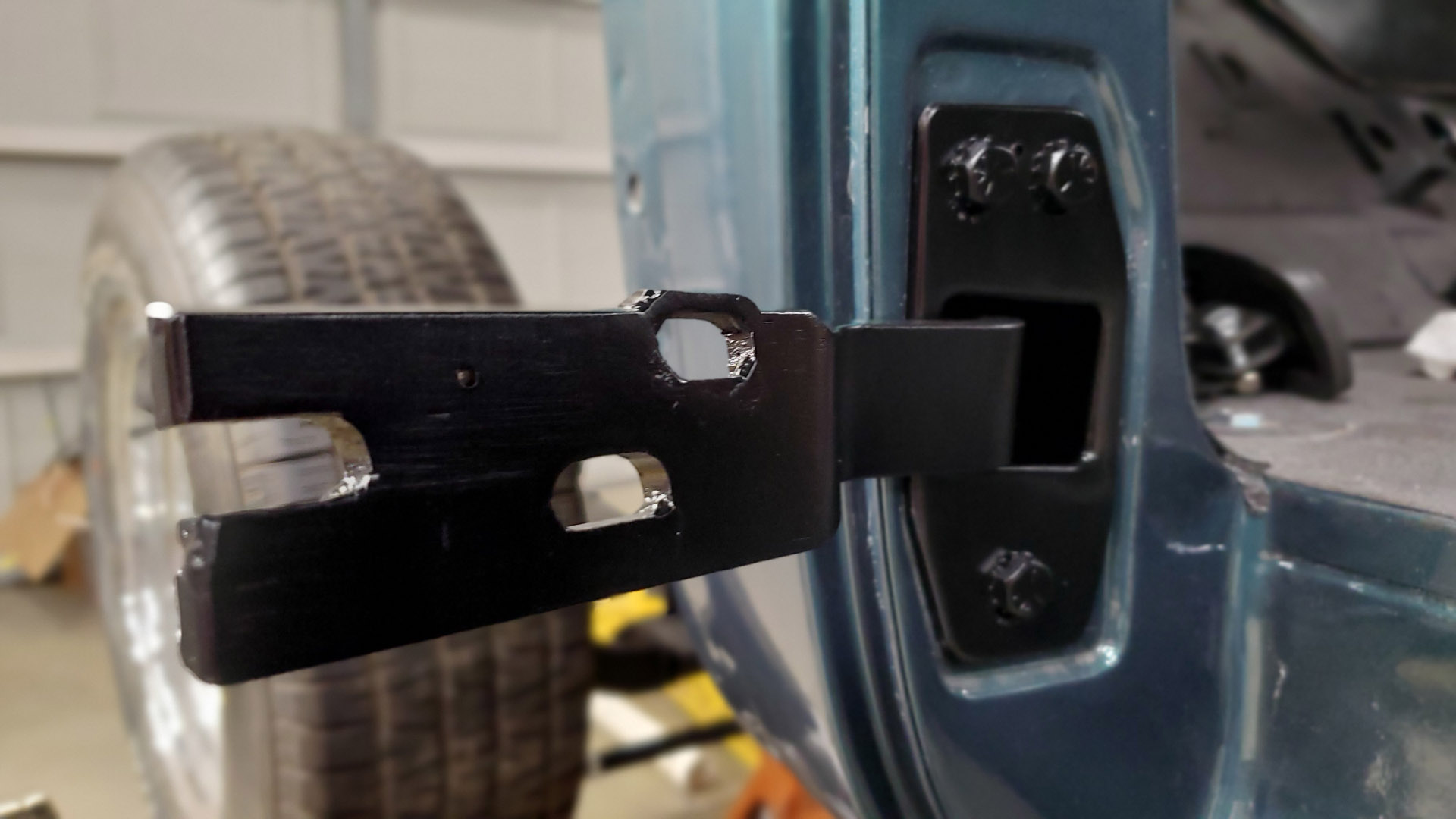 Slotted holes are relocated about 3/16" vertically. Size is maintained so that the bolts don't just crush the sheet metal of the door shell and maintain good clamping force.