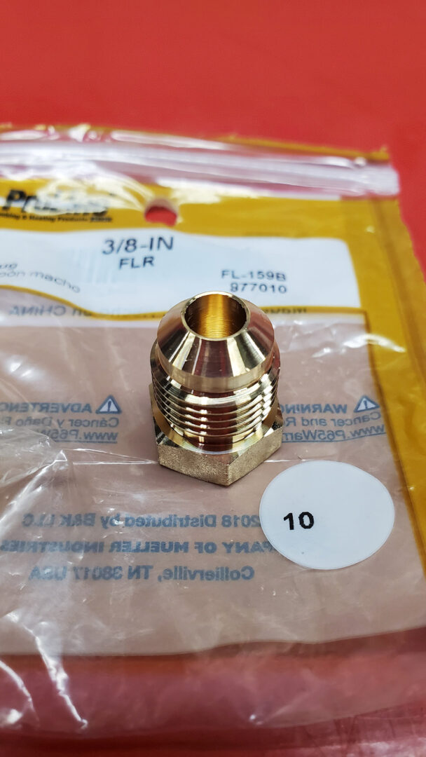 Nothing special here - just a common 3/8" flare plug. It has 1/2" straight cut threads (NPS) rather than tapered (NPT) threads you see on most modern engine fittings. The flare seals against the seat in the head where the old temperature probe lived.