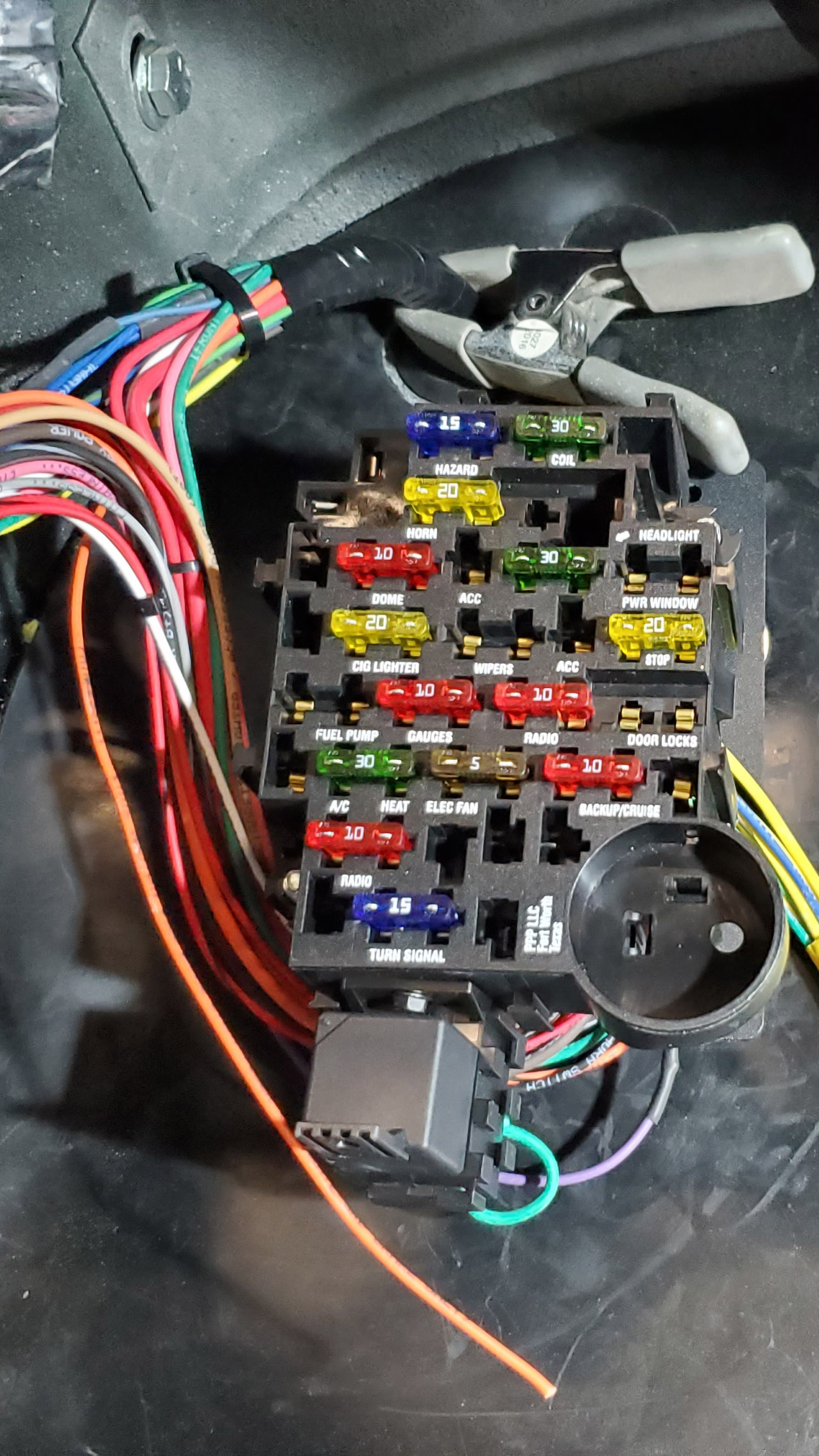 Fuse panel is mounted and a bundle of wires routed to the engine side